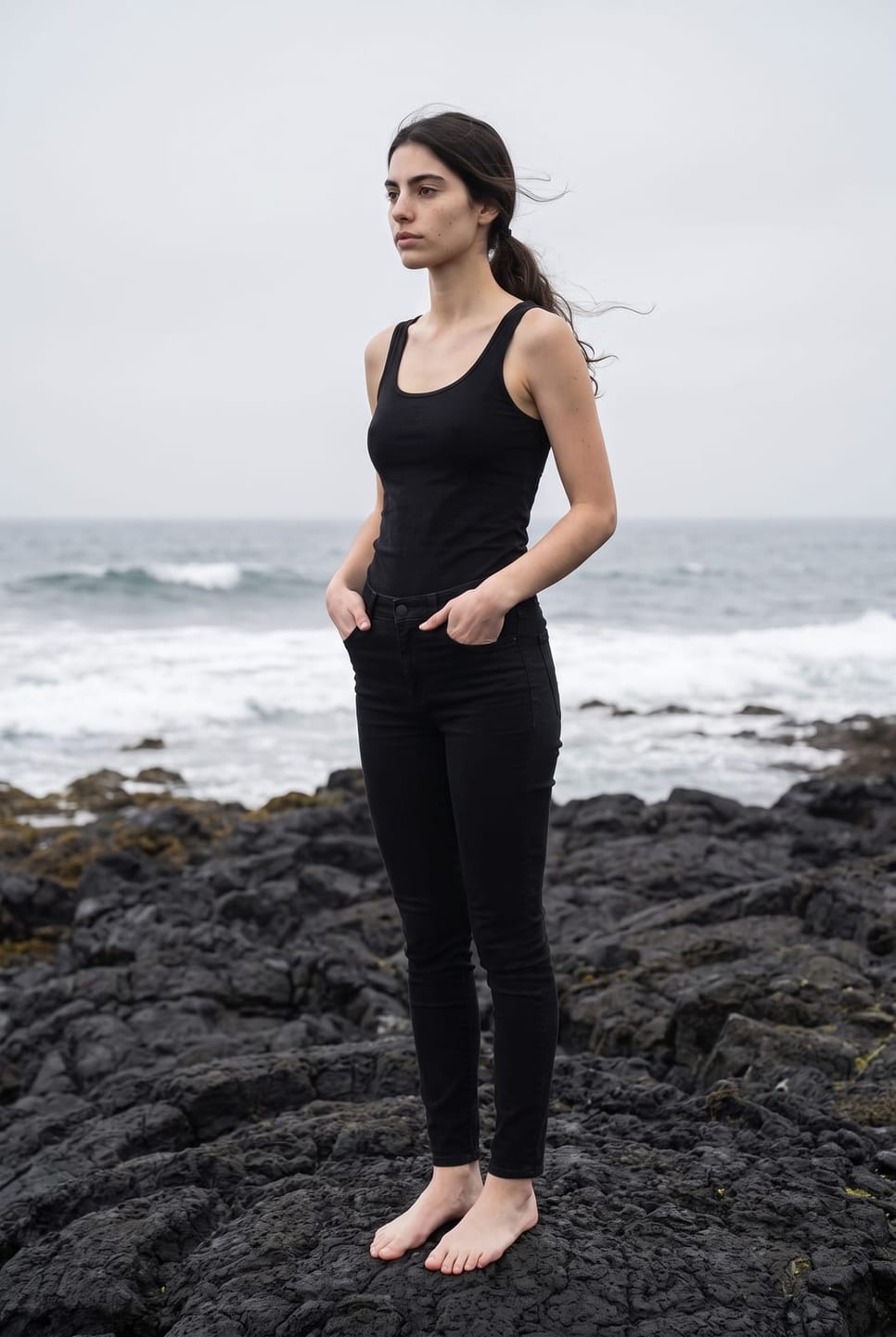 The same synthetic talent standing on black rock, hands in pockets, looking off camera — not a real person