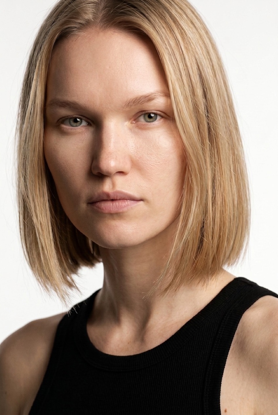 Synthetic talent, blonde bob, straight to camera — not a real person