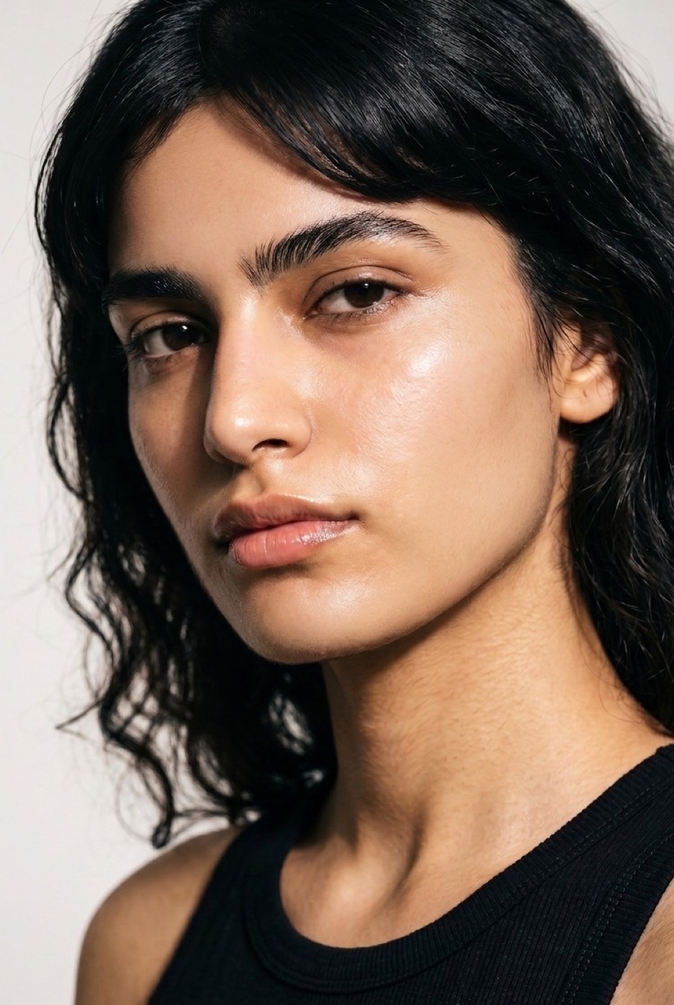 Synthetic talent, dark wavy hair — not a real person